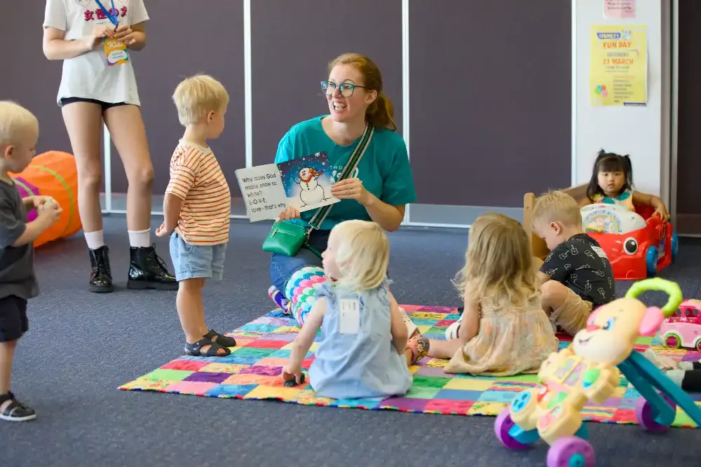 A OneHope Kids leader reading with young children