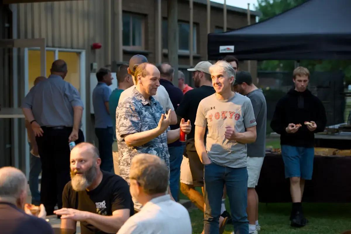 Men sharing food and conversation at Moolap
