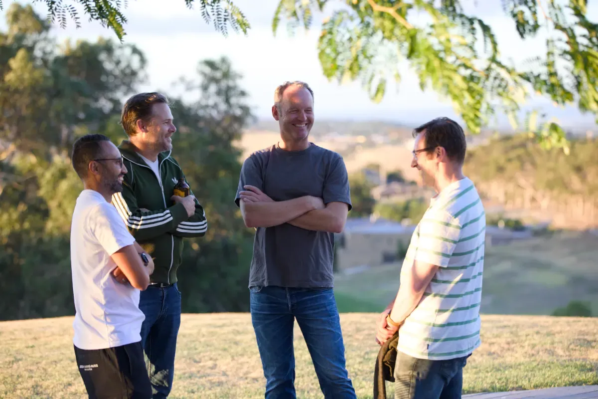 Men laughing together outdoors at OneHope